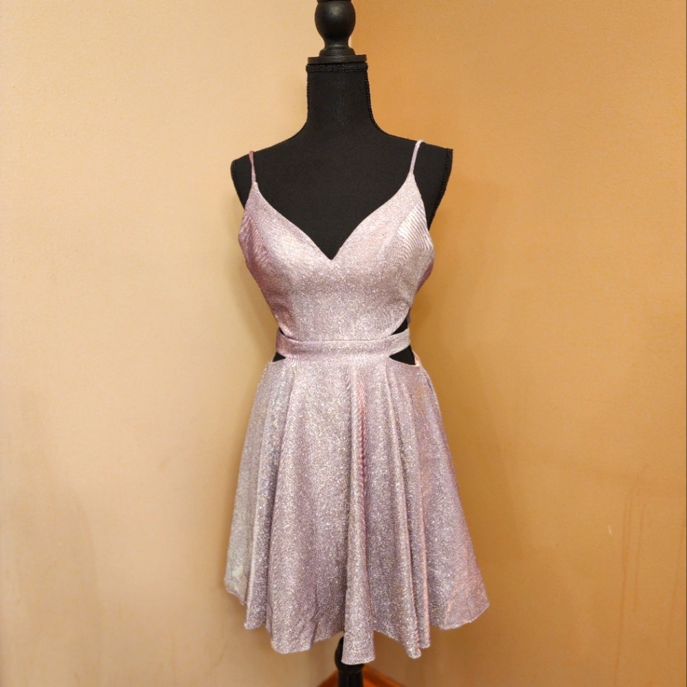 Size 0 homecoming or formal dress. Light purple shimmer with cut out sides.